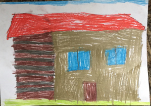 Praca Jakuba- szary dom z czerwonym dachem i niebieskimi oknami. Szczyt domu pomalowany w brązowo- szare pasy. W górze niebo, na dole trawa.